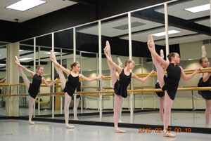 Dance Students stretching at the barre