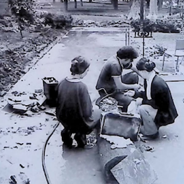 Chase Hall staff cleaning furniture and equipment after Hurricane Agnes.