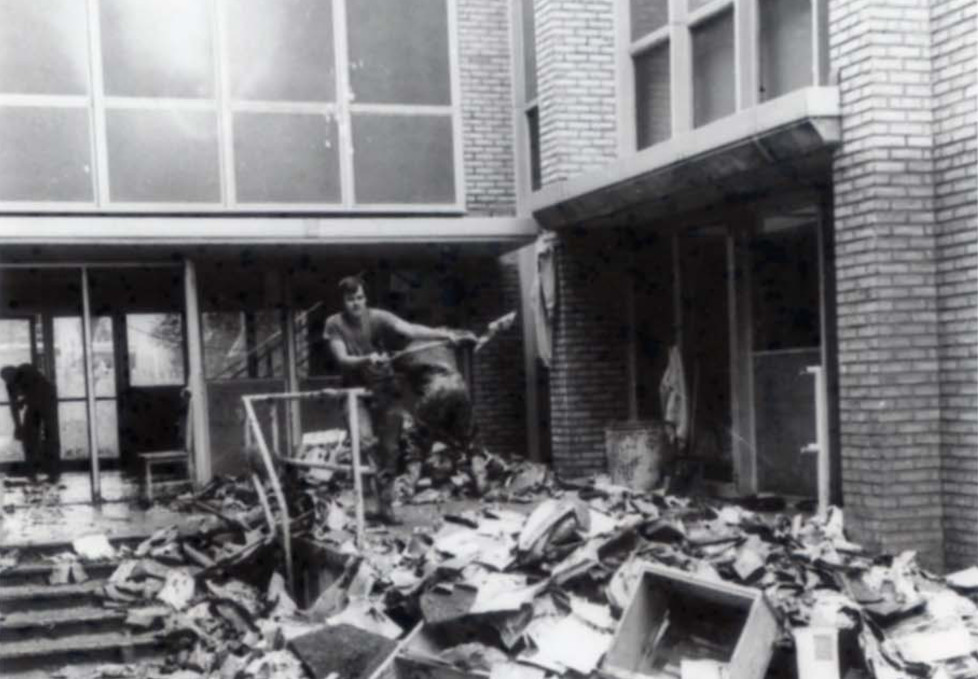 Men shoveling debris outside of Stark Hall