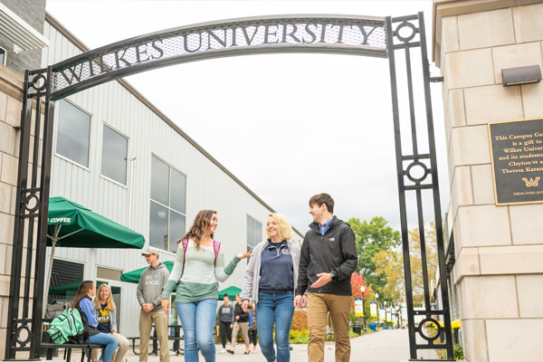 Students walk through the Karambelas East Campus Gateway.