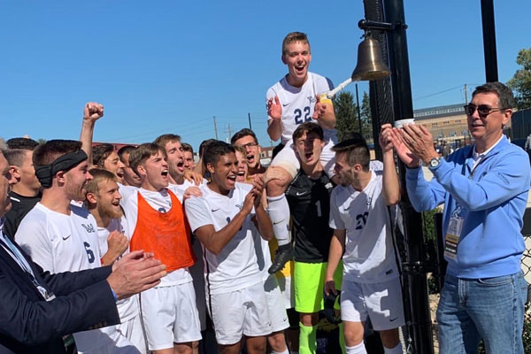 Student athletes celebrate a win by ringing the bell on Bruggeworth Field.