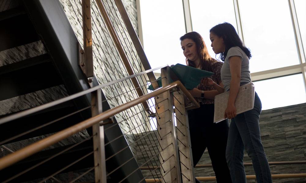 Students check an assignment on the stairwell in Cohen Science Center