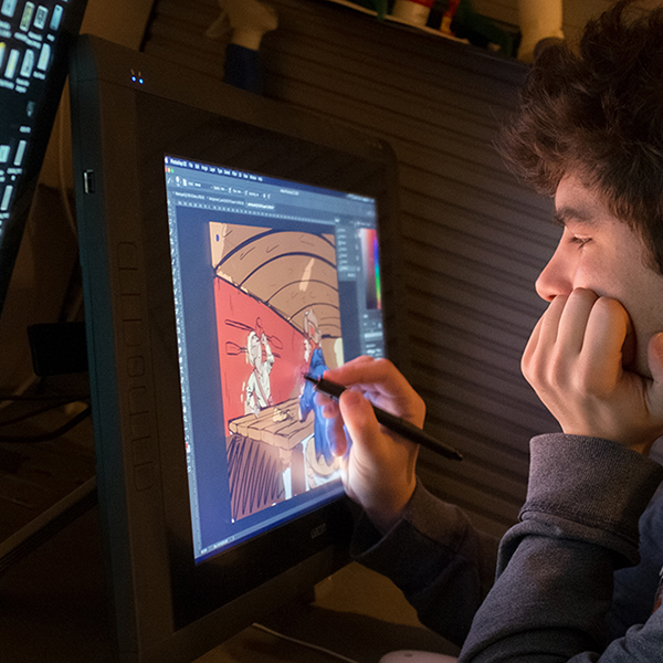 a student drawing on a large tablet computer