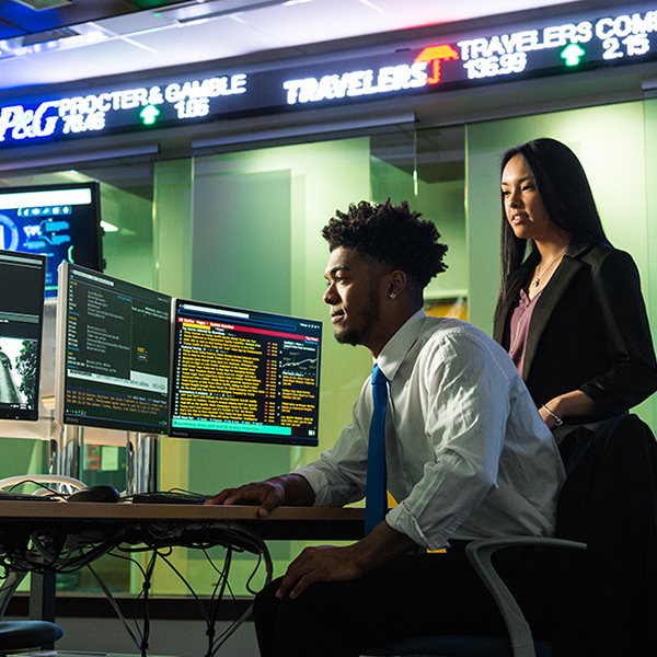 a professor and a student working in the financial lab
