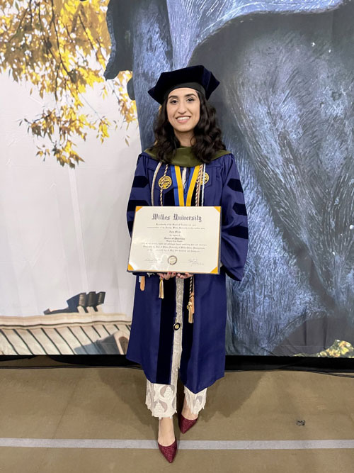 Zara Mirza in graduation regalia