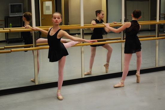 Dance Students stretching at the barre