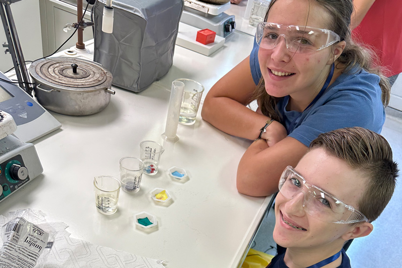 WEBS campers examine an experiment during an activity.