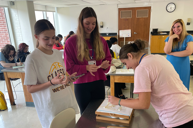Three WEBS campers collaborate on an experiment.