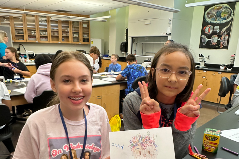 Two smiling WEBS campers take a fun photo.